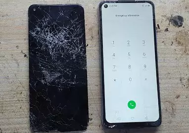 Cracked Infinix phone screen on AiPR technician office desk